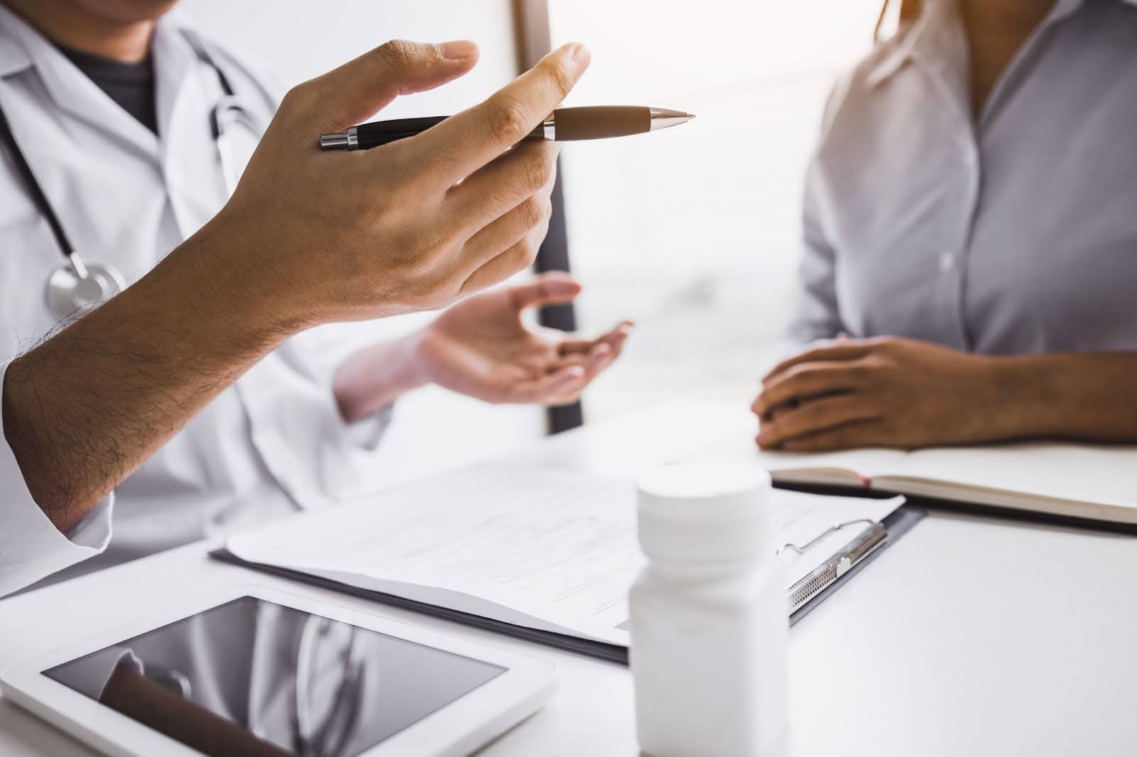 Two people near a clipboard.