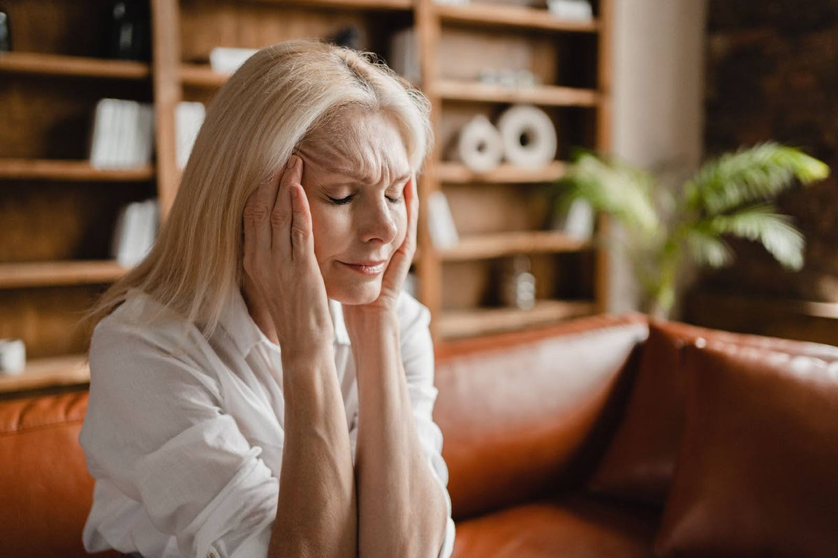 A distressed woman holding on to her face.