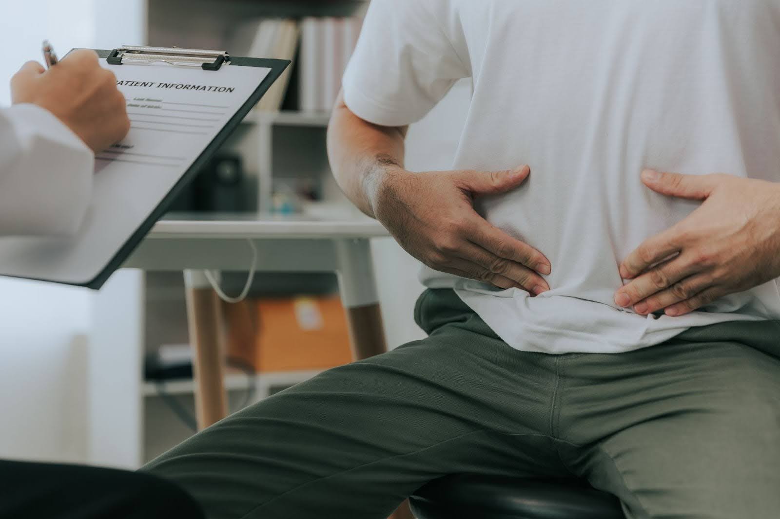 A man touching his belly.