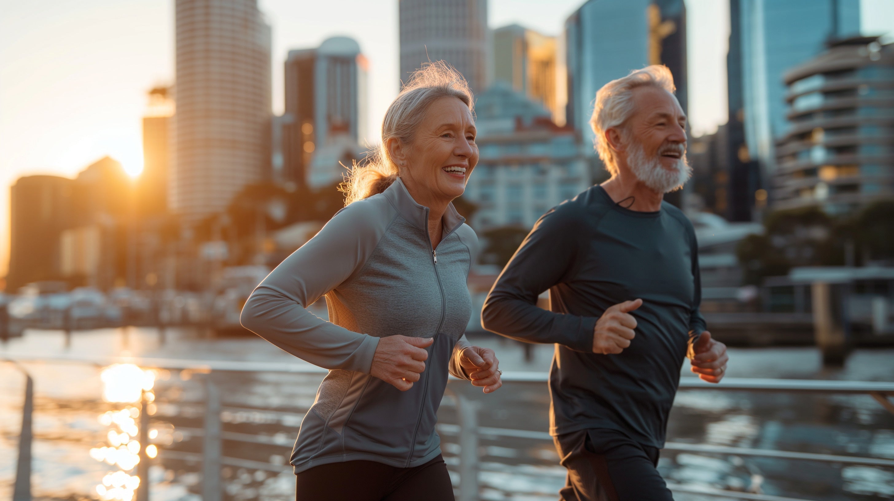A man and a woman jogging and smiling.