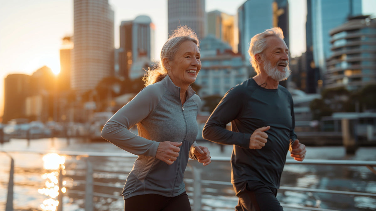 A man and a woman jogging and smiling.